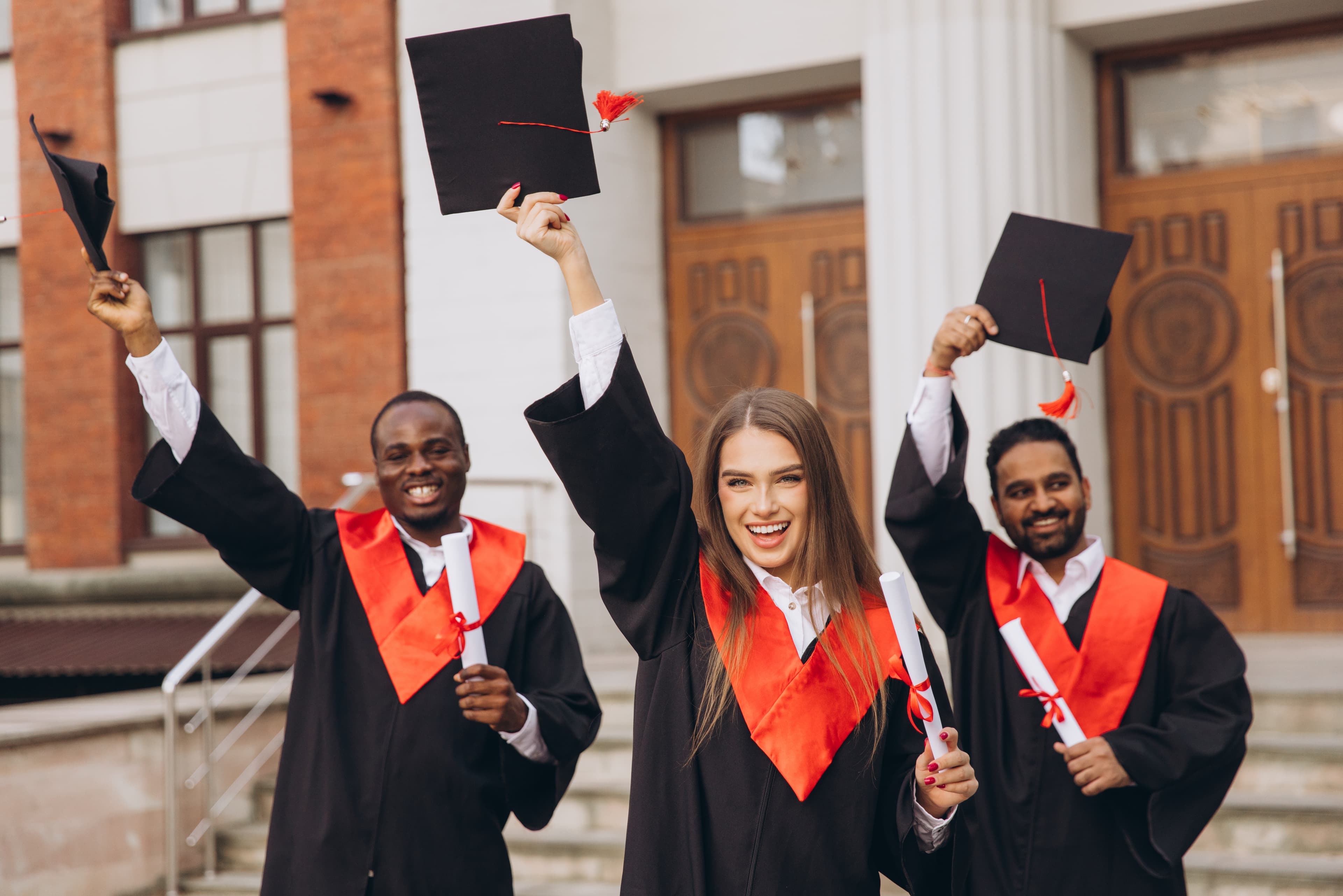 Many students jumping with graduation gown